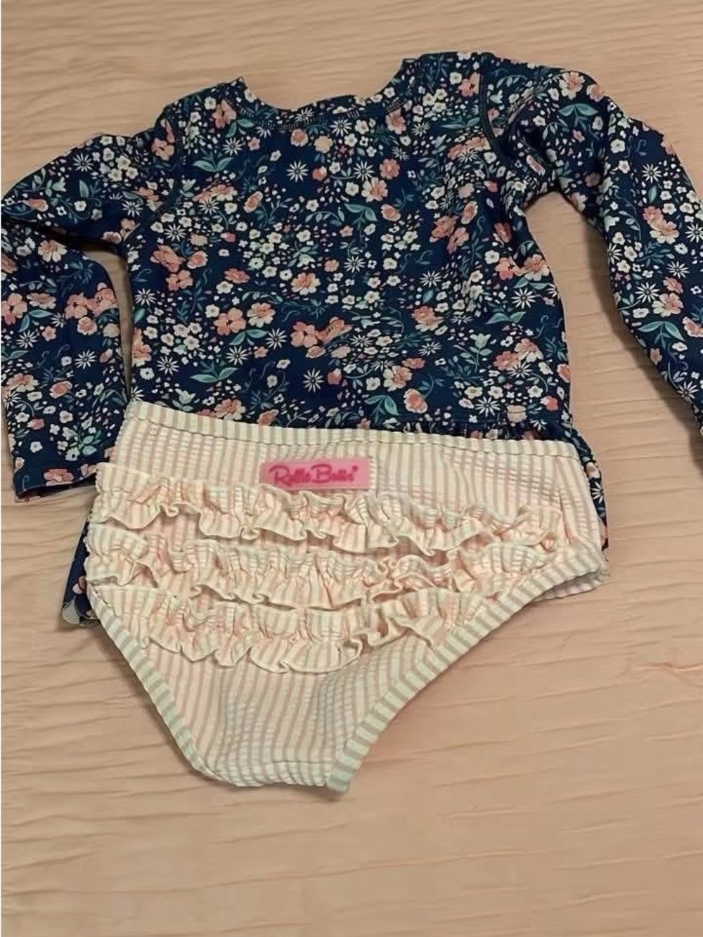Ruffle Butts Navy Floral Rash Guard with Pink Striped Ruffle Swim Bottoms